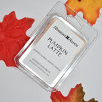 A clear clamshell package of Blossom Haven Pumpkin Latte scented wax melts, styled on a light gray background with decorative autumn maple leaves.