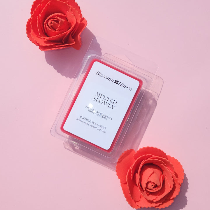 Wax melt packaging with red roses on a pink background