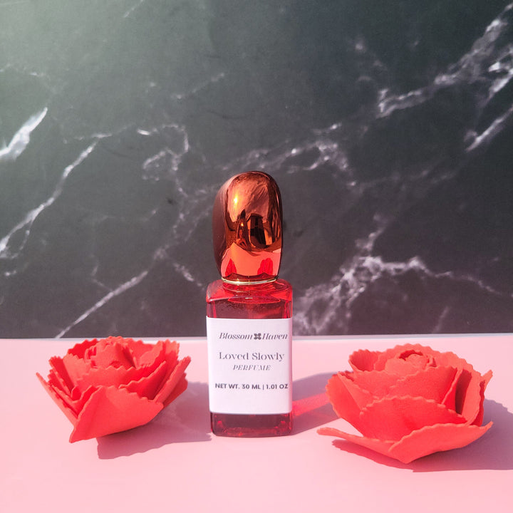 Red bottle with a label on a marble surface
